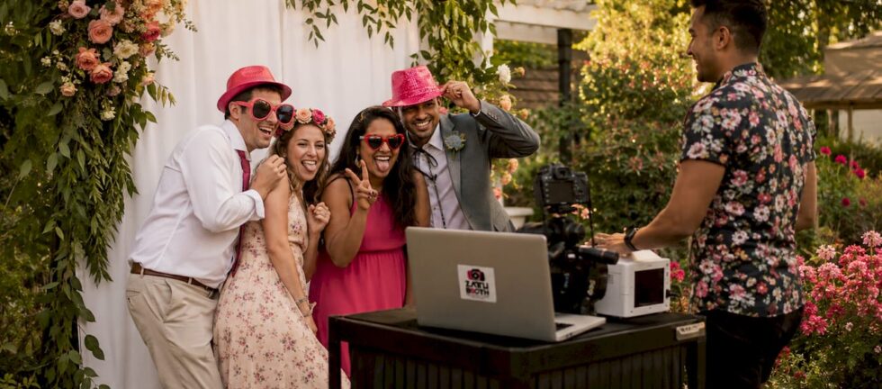 Guests enjoying a professional photo booth at wedding