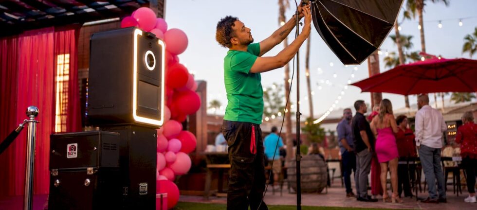 Technician adjusting photo booth lighting setup