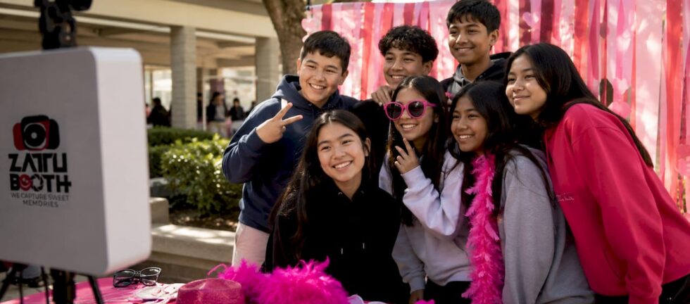 Students enjoying a school photo booth at gym event