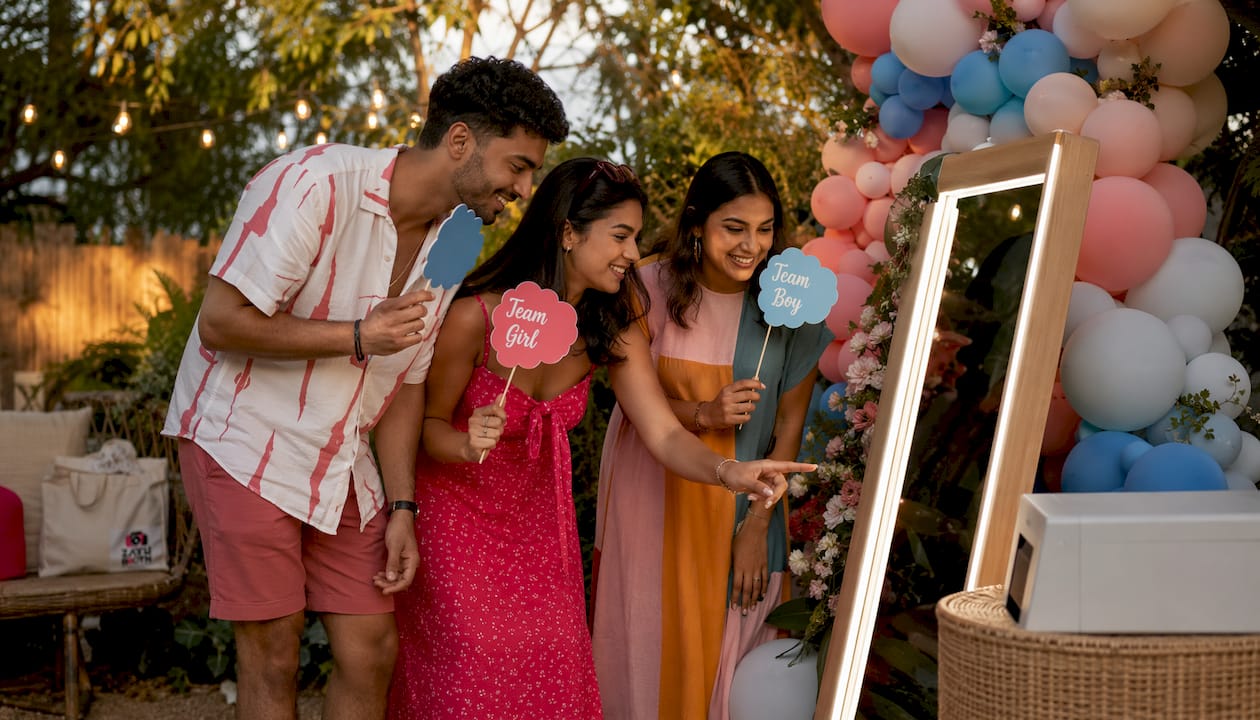 Guests using mirror photo booth with props